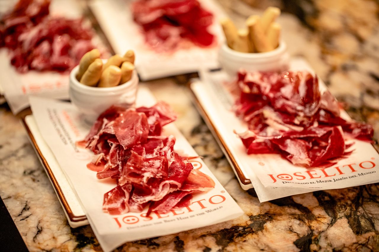 Hand-carved Joselito Ibérico ham laid out on a wooden serving board