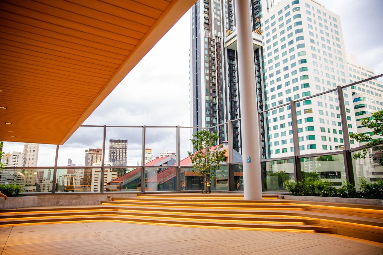 Latirra's outdoor terrace deck with tiered timber seating and a glass balustrade
