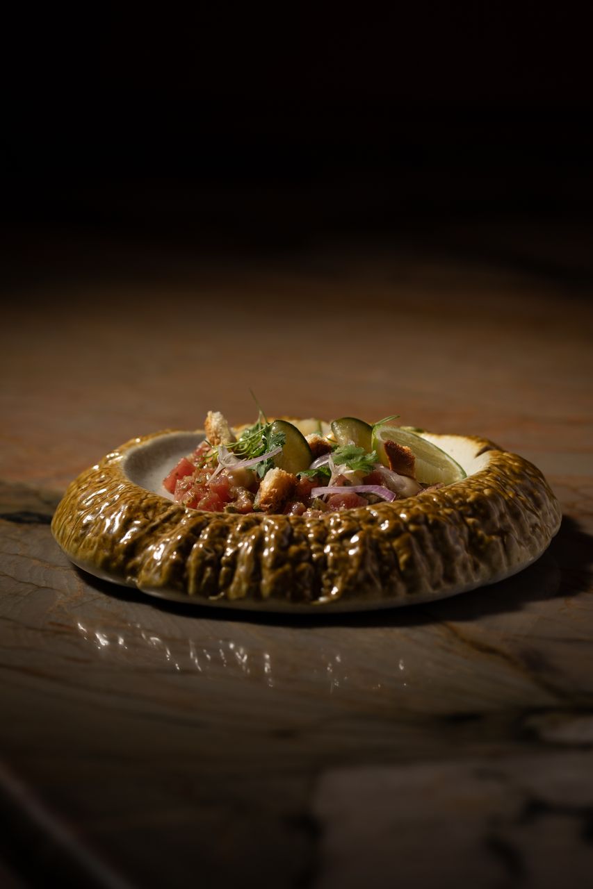Tuna tartare with cucumber, lime and red onion in a textured bowl